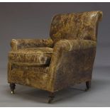 A Victorian leather armchair, upholstered in brown leather, with loose seat cushion, with front