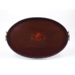 A mahogany tray, early 20th century, of oval form, designed with a central floral spray fruitwood