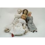 A group of three wax over composition dolls, circa. 1850-60, each in white dresses, varying