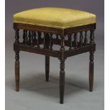 A late Victorian stained beech stool, the rectangular seat upholstered in green patterned fabric,