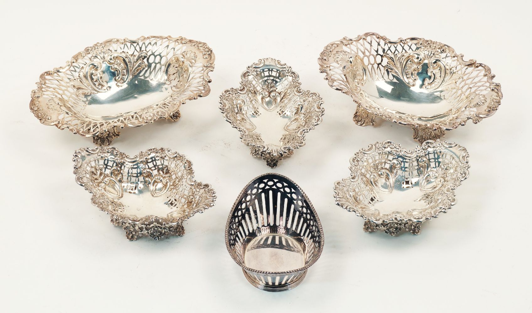 Six pierced silver bonbon dishes, the largest pair London, c.1892 & 1893, Sibray, Hall & Co (marks