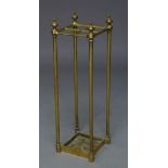 An Edwardian brass stick stand, with finialed top, having four divisions, raised on cylindrical