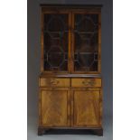 A George III style mahogany bookcase cabinet, late 20th Century, the dentil moulded cornice above