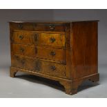 A figured walnut chest of drawers, 19th Century and later, with four graduated drawers, raised on