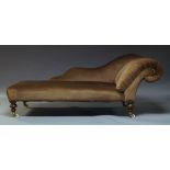 A Victorian Chaise Longue, with serpentine backrest and scrolling end, upholstered in brown velvet