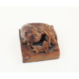 A Chinese hardstone seal, 19th century, carved as a mythical beast with cub atop a square base,