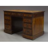 A late Victorian mahogany pedestal desk, the rectangular top inset with brown leather writing