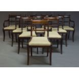 A set of ten Regency bar back dining chairs, with rope twist rails above cream upholstered drop in