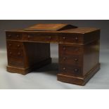 A Victorian mahogany partner's desk, the rounded rectangular top inset with brown leather writing