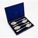 A cased set of four matched berry spoons, spurious marks, assumed silver, the repousse gilded