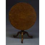 A George III pollard oak tilt top occasional table, the circular top on turned column support to