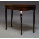A George III mahogany and crossbanded card table, the fold over top enclosing green baize lined