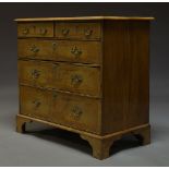 A George II style walnut and feather banded chest of drawers, 20th Century, the quarter veneered top