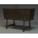 An elm chip carved chest, 19th Century, of tapered form, the hinged lid enclosing storage space