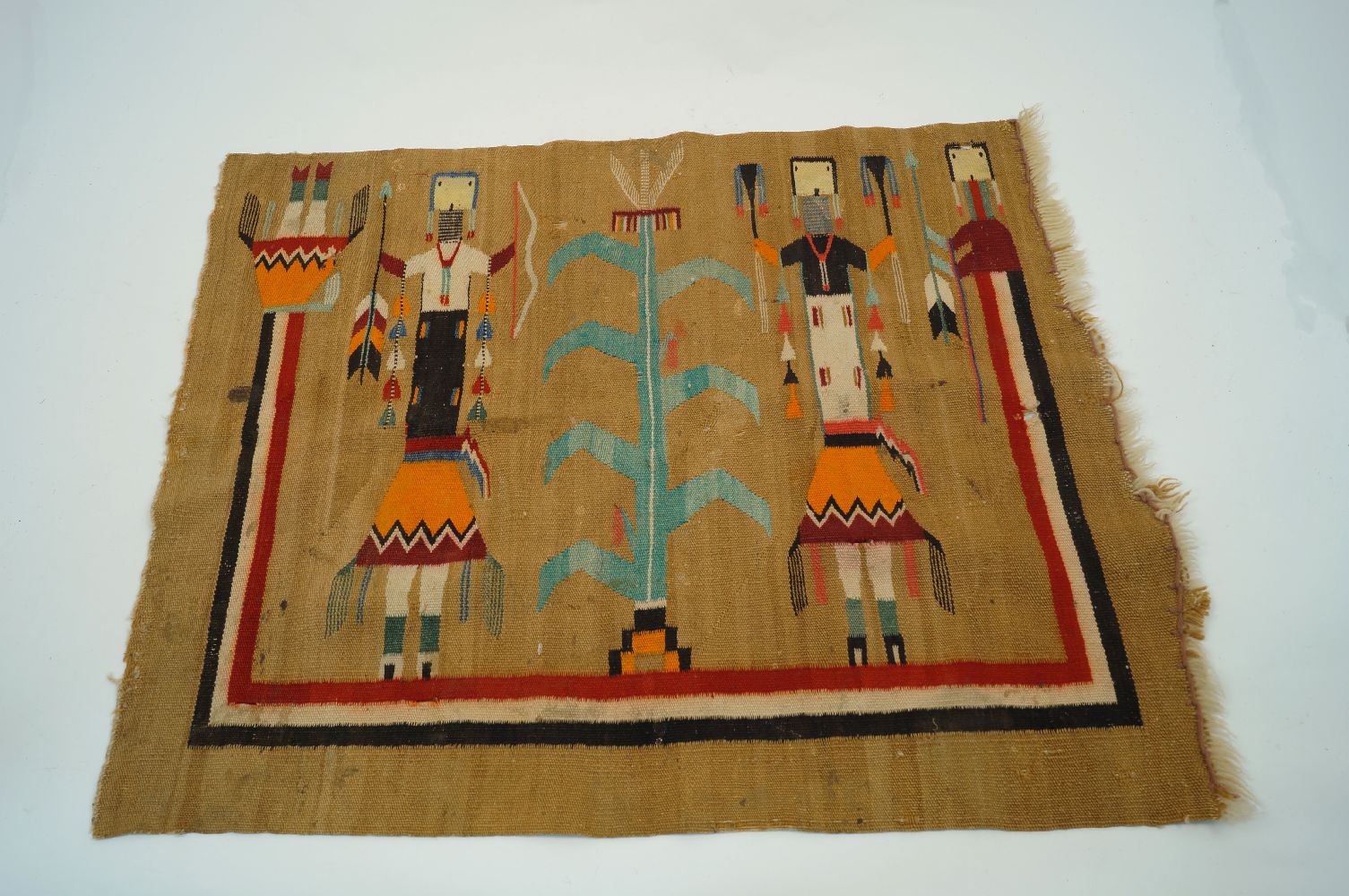 A Peruvian style prayer mat, 20th century, of rectangular form, designed with stylised polychrome