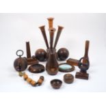 A collection of carved treen items, 19th century and later, to include a turned lignum vitae spill