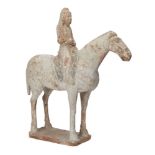 A Chinese pottery horse and rider, Tang dynasty, standing foursquare on a rectangular base, with