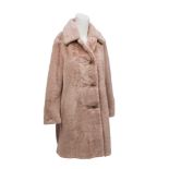 A Burberry faux fur single-breasted coat in pale blush, designed with distinctive vintage check