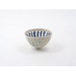 Dorothy Fiebleman (1951-), A small openwork bowl of cream ground with blue decorative designs to the