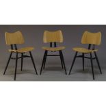 Ercol, a set of three beech and ebonised 'Butterfly' chairs, together with a set of four modern