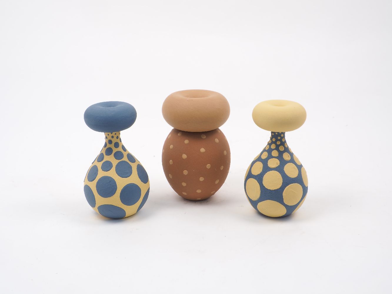 Jon Williams, a pair of glazed terracotta vases, one blue with yellow spherical splash decoration,