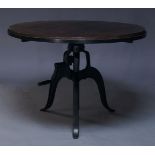 An Industrial style breakfast table, of recent manufacture, the circular veneered top on cast iron