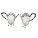 A hammered silver teapot and hot water jug, Birmingham, c.1911. Robinson & Co., each raised on