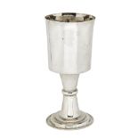 A large white metal goblet, unmarked, the plain cylindrical cup to waisted stem raised on stepped