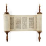 A miniature Sefer Torah mounted on ivory capped wooden rollers, probably 18th century, Germany or