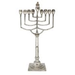 A large Art Deco menorah on a floral engraved square base, probably Polish c.1920, apparently