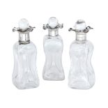 Three silver mounted whisky tot decanters, Birmingham, c.1928, William Devenport, each of squared