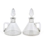 A matched pair of conical silver mounted glass decanters, one Birmingham, c.1907, John Charles