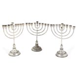 A pair of silver menorahs, by Hazorfim, stamped 925, each raised on a stepped circular foot