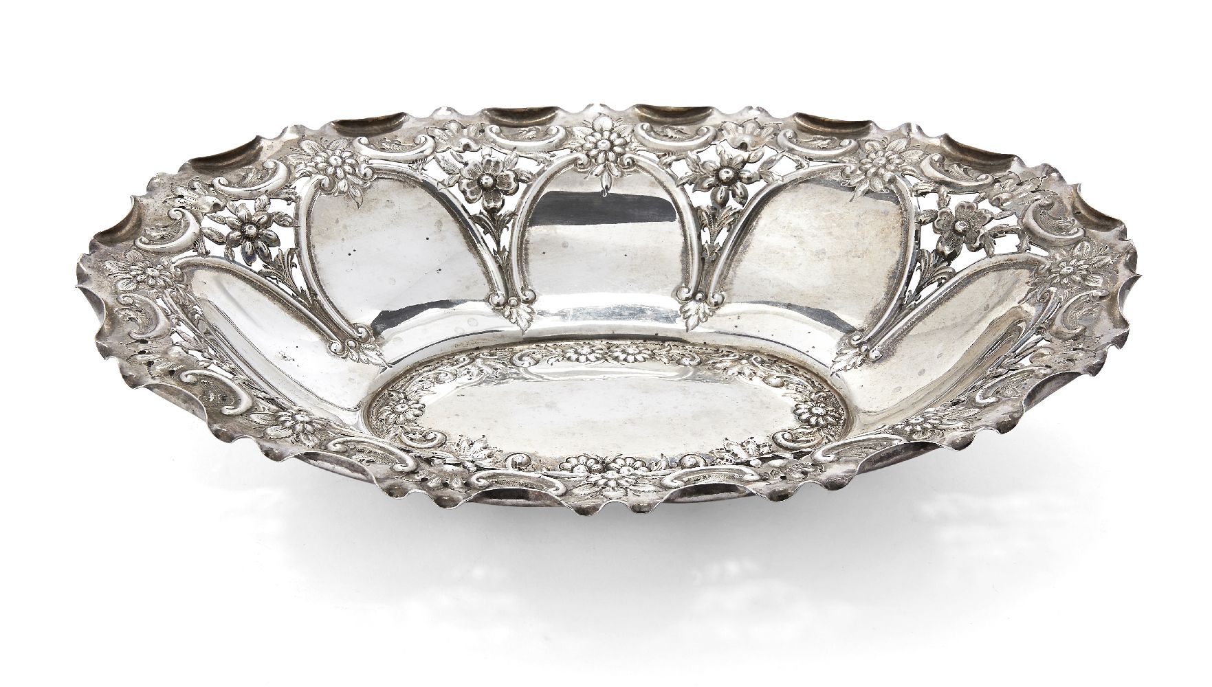 An Edwardian pierced silver repousse dish, Chester, c.1910, James Deakin & Sons, of shaped oval