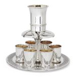 A modern Israeli Kiddush set by Hazorfim, stamped 925, the circular base with textured border, the