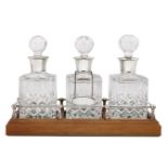 A set of three silver mounted decanters, all Birmingham, c.1986, Charles S Green & Co Ltd, on a