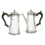 A pair of silver café-au lait pots, London, c.1932 and 1934, Theodore Rossi, of tapering cylindrical