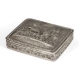 A white metal snuffbox, of rectangular form, the repousse lid depicting scene of figure in lion-