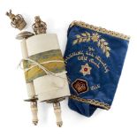 A miniature Sefer Torah mounted on ivory tipped rollers with gilt crown finials (one detached),