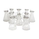 A large collection of silver mounted whisky tots, comprising thirty glass tots with silver collars