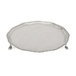 A shaped silver salver with gadroon rim, Sheffield, c.1946, Roberts & Belk, raised on three claw and