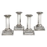 A matched set of four Victorian silver candlesticks, Sheffield, c.1887 and 1896, James Deakin &
