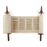 A miniature Sefer Torah Scroll mounted on carved wooden rollers, the text written on vellum in a