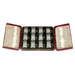 A cased set of twelve Hanau silver and glass liqueur glasses, the silver holders with London