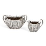 A matched repousse silver cream jug and sugar, Birmingham, c.1911 and c.1891, makers HIM and LS,