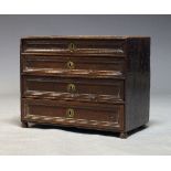 A Continental chest, 17th Century, of diminutive proportions, with four graduated drawers, raised on