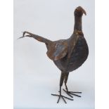 A pair of modern folk art style metal pheasants, each of stylised minimalist form, modelled