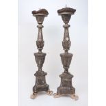 A pair of carved wood candlesticks, early 20th century, of stylised knopped form, with foliate