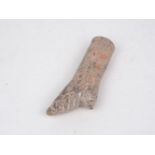 A Chinese clay model of a 'lily foot', Tang dynasty, carved as a bound foot, 14cm long Provenance: