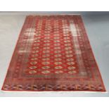A Turkoman carpet with four rows of guls in a red field with multiple border, 315cm x 204cmPlease